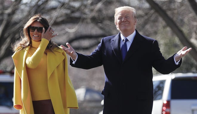 President Donald Trump and first lady Melania Trump pause as they walk to Marine One across the South Lawn of the White House in Washington, Monday, Feb. 5, 2018, for the short trip to Andrews Air Force Base en route to Ohio. (AP Photo/Carolyn Kaster)