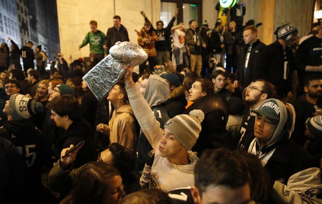 Philadelphia Eagles fans celebrate the team's victory in the NFL Super Bowl LII against the New England Patriots. A parade is set for Thursday. [AP Photo/Matt Rourke]