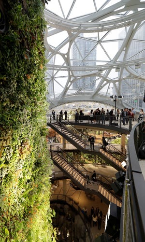 Gathering spaces and a plant-filled wall are part of the Amazon Spheres, plant-filled geodesic domes that are new work- and gathering spaces for Amazon.com employees. [AP Photo / Ted S. Warren]