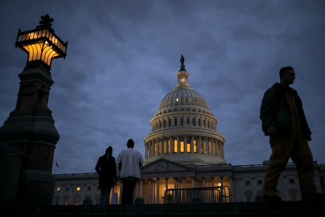In this Jan. 21, 2018, file photo, lights illuminate the U.S. Capitol on second day of the federal shutdown as lawmakers negotiate behind closed doors in Washington. The era of trillion-dollar budget deficits is about make a comeback _ and a brewing budget deal hastened the arrival. Lawmakers are inching closer to a two-year, budget-busting spending pact that would give whopping budget increases to both the Pentagon and domestic programs have been inching closer to an agreement, according to aides and members of Congress. (AP Photo/J. Scott Applewhite, File)