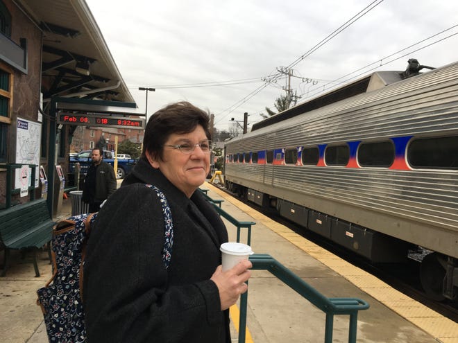 New Britain Borough resident Cristi Charpentier waits at the Doylestown Borough train station Tuesday morning for a train to take her in to work in Philadelphia. Charpentier, a federal public defender, said she's not worried about the crowds expected Thursday morning for the Eagles Super Bowl parade. [Marion Callahan/Staff photojournalist]