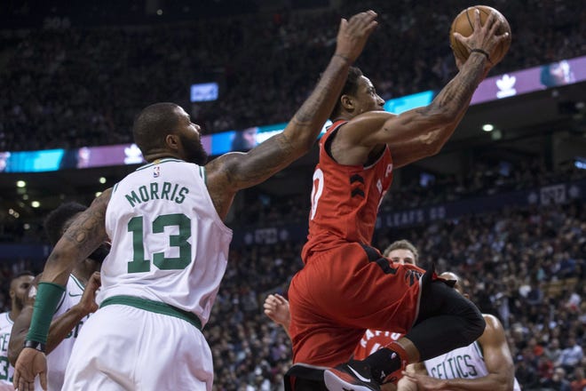 Toronto's DeMar DeRozan glides to the basket past the defense of Celtics forward Marcus Morris during the second half of Boston's 111-91 loss to the Raptors on Tuesday night.