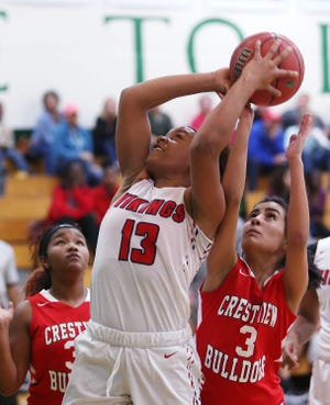 Tanyria Tassin takes a shot as Aliyiah Brown defends during the Fort Walton Beach - Crestview girls semifinal basketball game at Choctaw. [MICHAEL SNYDER/DAILY NEWS]