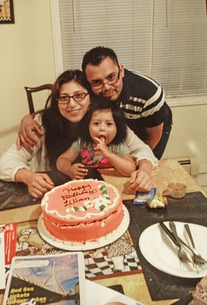A family photo shows a birthday celebration for Lilian Calderon, a Guatemalan native who has been living in Providence but who is now in ICE custody in Boston. [The Providence Journal / Sandor Bodo]