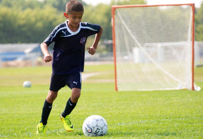 Alvin Hernandez, 6, scrimmages with other Raptors youth soccer players on Friday, Aug. 1, 2014, at the kick-off to construction for Reclaiming First, an expansion of Sportscore Two in Loves Park. [RRSTAR.COM FILE PHOTO/KEVIN HAAS]