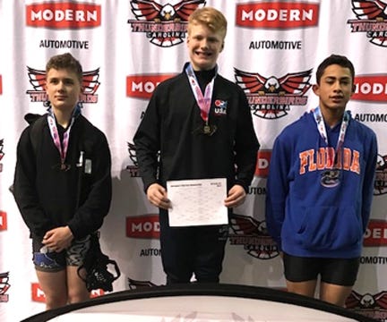 Burns Middle School’s Silas Tate stands at center with the runnerup finishers at the Junior High State Wrestling Championships this past weekend in Winston-Salem. Tate sailed through the 162-pound weight class to win the title and complete an unbeaten season. [Special to The Star]
