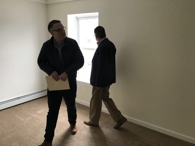 Norwich Public Utilties spokesman Chris Riley and Division Manager Steve Sinko look at a bedroom in a fully renovated unit at the Taftville apartments. [Stephanie Menders/NorwichBulletin.com]