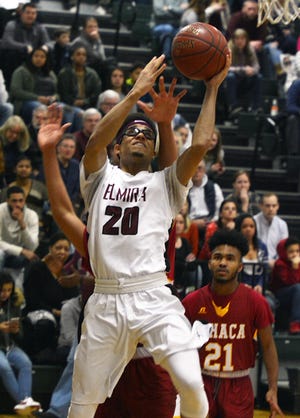 Elmira's Taisean Horton cuts past an Ithaca defender for a layup in the first half. [ERIC WENSEL/THE LEADER]