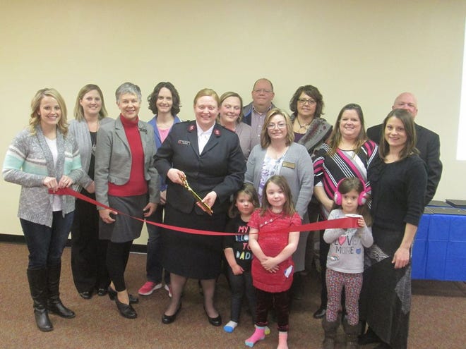The Salvation Army and members of the Canton Area Chamber of Commerce join together in a ribbon cutting marking the remodeling of the Salvation Army building.