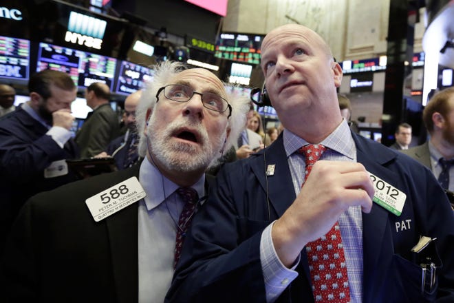 Traders Peter Tuchman, left, and Patrick Casey work on the floor of the New York Stock Exchange, Thursday, Feb. 8, 2018. U.S. stocks are lower Thursday morning as losses from the previous day continue. (AP Photo/Richard Drew)