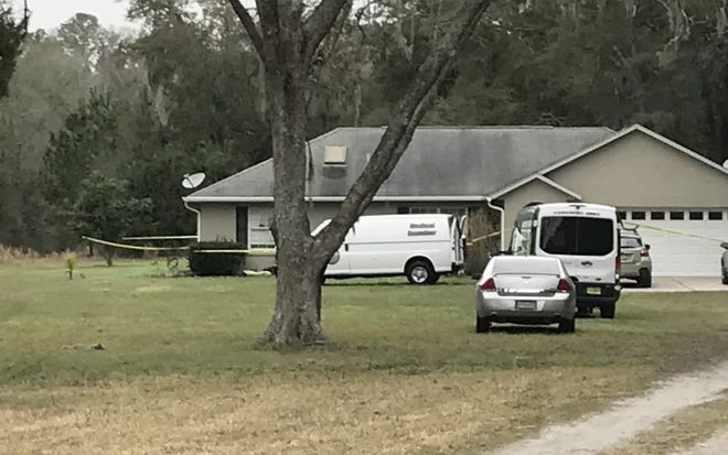Officials investigate the deaths of a man and woman at a home in the 1300 block of Southeast 95th Street Thursday morning. [Austin L. Miller/Star-Banner]