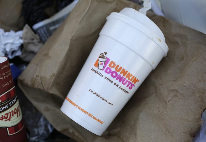 In this Feb. 14, 2013, file photo, a Dunkin' Donuts' foam cup is discarded in a trash bin in New York. Dunkin' Donuts said Wednesday, Feb. 7, 2018, that the polystyrene foam cups will be completely phased out from all its stores globally by 2020. (AP Photo/Mark Lennihan, File)