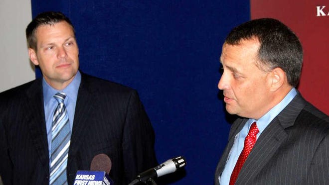 In this 2012 file photo, Shawnee County election commissioner Andrew Howell, right, is pictured after being appointed by Kansas Secretary of State Kris Kobach. Howell said a reform measure being considered at the Capitol should be defeated because it would “strip the election commissioners of the independent status as envisioned by the Legislature." [2012 file photo/The Capital-Journal]