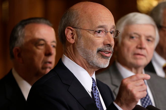 Pennsylvania Gov. Tom Wolf, center, accompanied by state House Minority Leader Rep. Frank Dermody, right, D-Allegheny, and state Rep. Joe Markosek, left, D-Allegheny, discuss state budget negotiations at the state Capitol in Harrisburg, Pa. Republican leaders of the Pennsylvania Legislature said Friday. Wolf wants counties that choose to buy new voting machines to purchase ones with a paper backup. [AP Photo/Matt Rourke, File]
