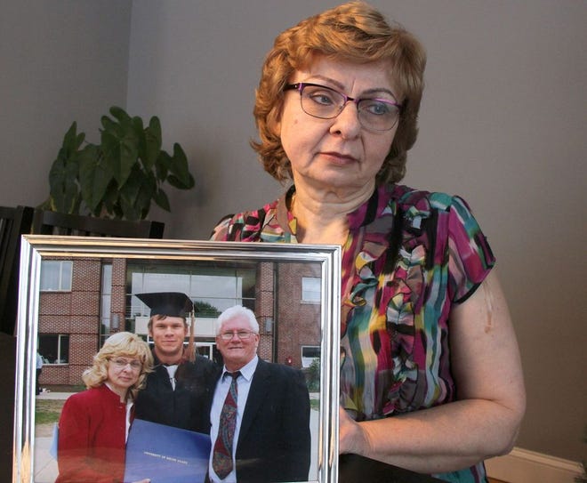 Anna Fudali with a photograph taken at her son Wojciech's graduation from the University of Rhode Island in 2008. Proficient in English, Polish, Spanish and German, Wojciech earned a degree in international business. Months later, he would disappear without a trace. The photo shows Wojciech with his parents, Anna and Ryszard Fudali. [The Providence Journal / Steve Szydlowski]