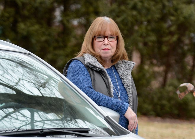 Deb Jadofsky, of Oakdale, stands with her new Nissan Sentra. Jadofsky was involved in a crash in 2012 where her seat belt helped save her life. [Aaron Flaum/NorwichBulletin.com]