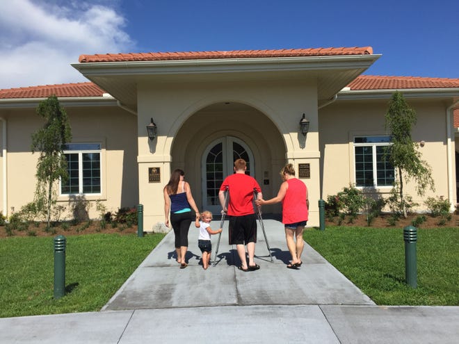A family enters the Fisher House of the Emerald Coast, at Eglin Air Force Base. Fisher House provides free lodging for military families while service members are undergoing medical treatment. [CONTRIBUTED PHOTO]