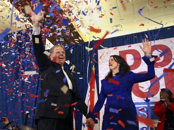 Democratic candidate for U.S. Senate Doug Jones and his wife Louise wave to supporters before speaking Tuesday, Dec. 12, 2017, in Birmingham, Ala. [AP Photo/John Bazemore, File]