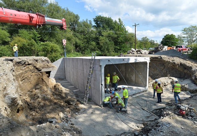 Contractors replace a structurally deficient bridge on Route 98 over Falk Run in Franklin Township in August. The old bridge was built in 1922. [FILE PHOTO/ERIE TIMES-NEWS]