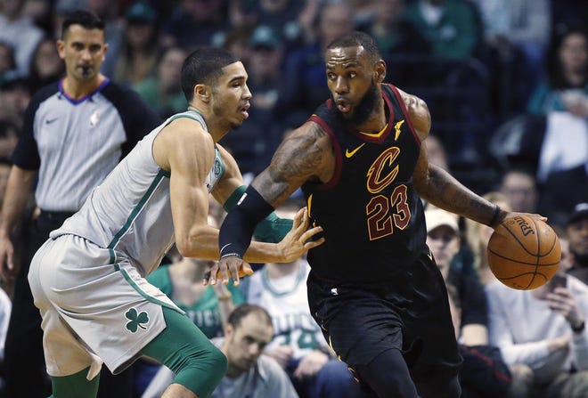 Cleveland Cavaliers' LeBron James (23) drives past Boston Celtics' Jayson Tatum during the second quarter of an NBA basketball game in Boston, Sunday, Feb. 11, 2018. (AP Photo/Michael Dwyer)