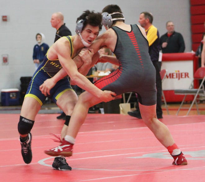Aidan Petersen, of Hillsdale, gets aggressive during the MHSAA individual districts competition at Michigan Center High School on Saturday. [ANDREW KING PHOTO]
