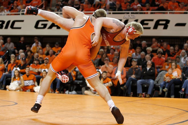 Oklahoma State's Derek White wrestles Oklahoma's Connor Webb in the 285-pound match during a Bedlam college wrestling dual between the Oklahoma State Cowboys (OSU) and the University of Oklahoma Sooners (OU) at Gallagher-Iba Arena in Stillwater, Okla., Sunday, Feb. 11, 2018. Photo by Bryan Terry, The Oklahoman