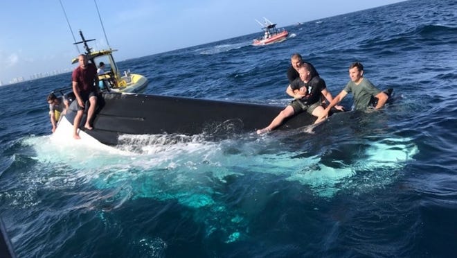Rescue of five men from capsized boat (U.S. Coast Guard)