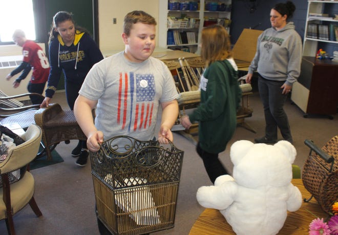 North Adams-Jerome fifth grade students organize items donated for her class's rummage sale. [ANDREW KING PHOTO]