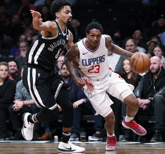 Nets' Spencer Dinwiddie (8) defends Clippers' Lou Williams during the first half. [THE ASSOCIATED PRESS]