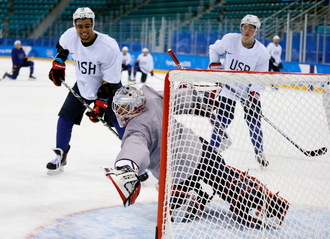 United State's goalie Brandon Maxwell reaches for a puck as Jordan Greenway, left, and Ryan Donato watch during practice ahead of the 2018 Winter Olympics on Feb. 9 in Gangneung, South Korea. [AP Photo/Kiichiro Sato]