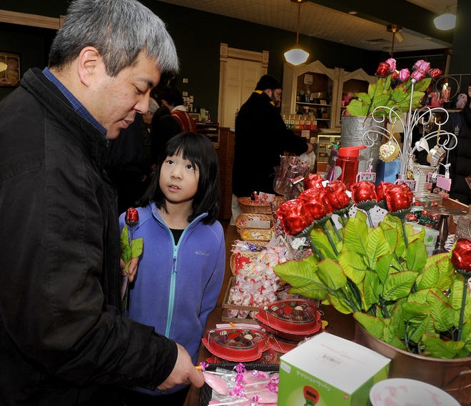 Peter Miyamoto and his daughter Lauren, 9, shop for a Valentine's Day gift for his wife Tuesday at The Candy Factory. The pair settled on chocolate and a gift for Lauren's teacher. The Candy Factory is one of Columbia's busiest stores this week as gift givers shop for chocolate-covered strawberries and other sweet expressions of love. [Don Shrubshell/Tribune]