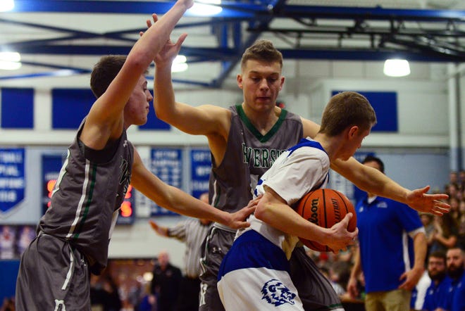 Ellwood City's Broc Boariu is surrounded by Riverside's Sam McQuiston, center, and Ty Thellman, left, during their game at Lincoln High School in Ellwood City earlier this season. Ellwood City and Riverside's boys basketball teams will play in the WPIAL playoffs on Friday night. [Lucy Schaly/BCT staff]