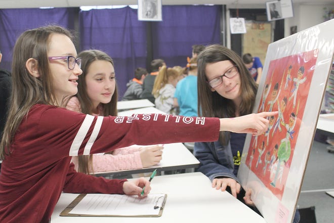 Jonesville Middle School student Gracen Hager points out features in a painting to Kamdyn Todd and Tabitha Vest. [COURTESY PHOTO]