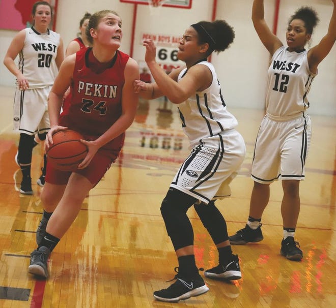 Pekin's Tess Cascia drives to the basket against Normal West. It was the first postseason game for Cascia, a freshman.