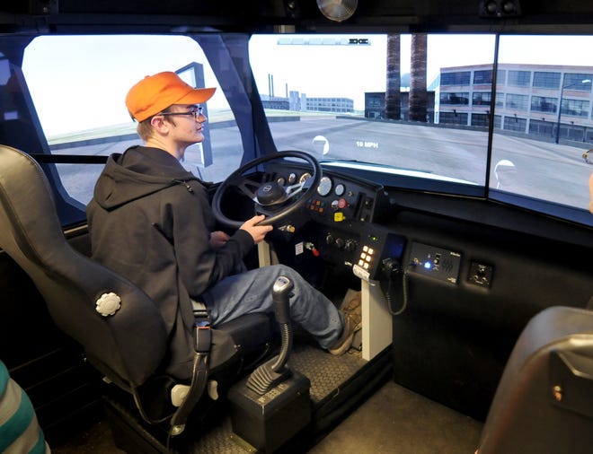 Tripp Goossen, 16, of Beverly, uses a truck driving simulator Tuesday afternoon during an open house at Salina Area Technical College. [TOM DORSEY / SALINA JOURNAL]