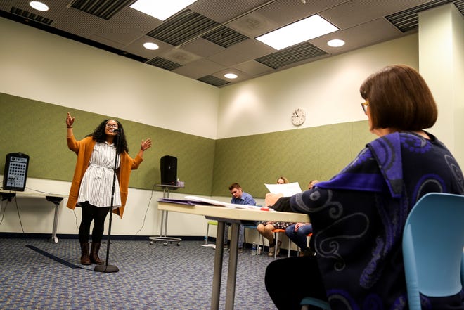 Hickman High School senior Shakira Cross recites a poem during the Poetry Out Loud Central Missouri Regional Competition at the Columbia Public Library on Wednesday. Eight high school students competed for three rounds and recited poems from memory. Cross won the competition and advanced to the state competition. [Hunter Dyke/Tribune]