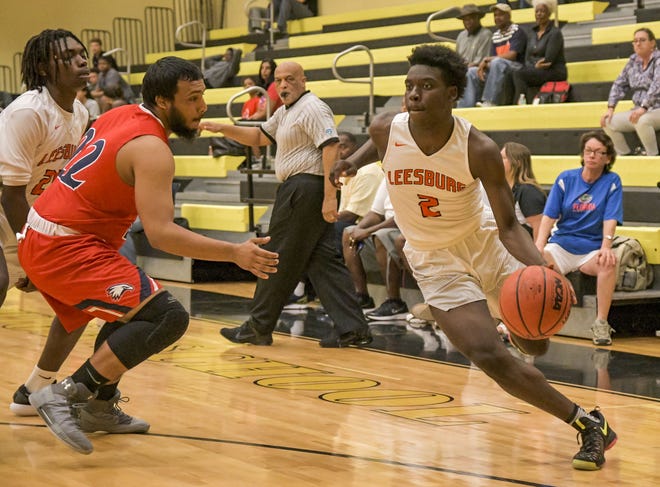 Leesburg's Lance Erving (2) drives to the basket at a Class 6A-District13 semifinal game against Poinciana on Tuesday in Orlando. Leesburg will face Bishop Moore in the final on Friday. [PAUL RYAN / CORRESPONDENT]