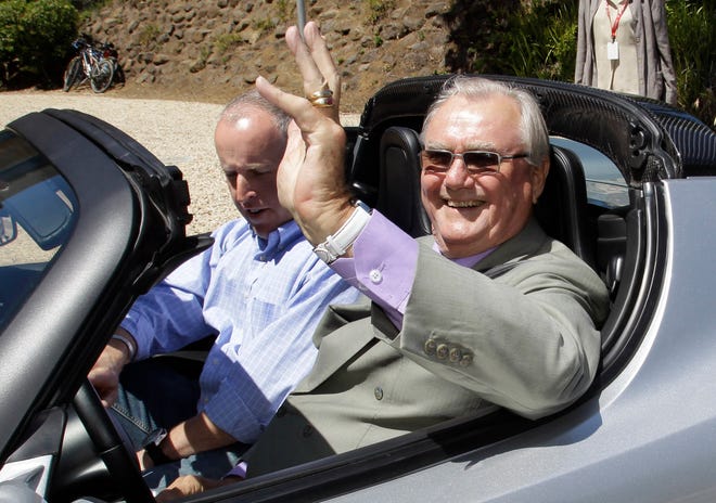 FILE - In this June 13, 2011, file photo, Denmark's Prince Henrik, right, waves as he drives a Tesla Roadster at the electric car maker's headquarters in Palo Alto, Calif. Denmark's royal palace says the 83-year-old Prince Henrik, has been transferred from a Copenhagen hospital to the family's residence north of the capital "where he wishes to spend his last moments." (AP Photo/Paul Sakuma, File)