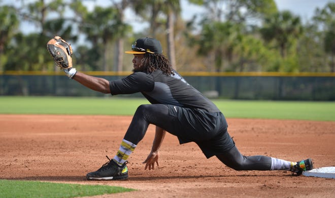 Pirates first baseman Josh Bell stretches to make a catch Wednesday, the first day of spring training for Pittsburgh PIrates pitchers and catchers. Some position players are already practicing but the Pirates' first full squad workout is Monday.  [Herald-Tribune staff photo / Mike Lang]