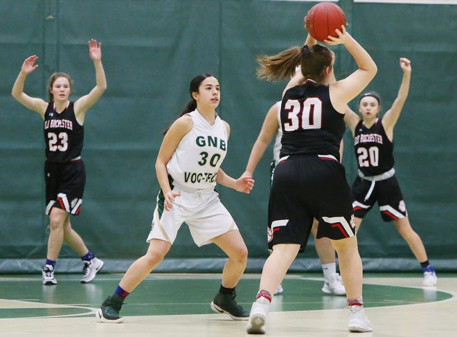 Old Rochester's Mary Butler, left, and Cassidy Yeomans, right, signal for the ball from teammate Kat Tracey as GNB Voc-Tech's Jayda Fortin defends. [MIKE VALERI/THE STANDARD-TIMES/SCMG]