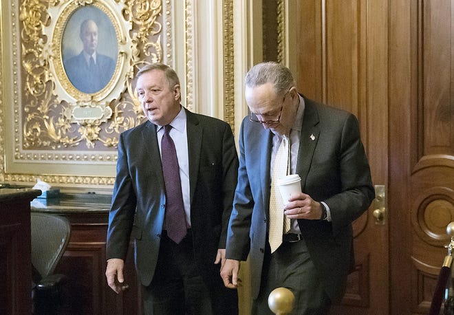Sen. Dick Durbin, D-Ill., left, and Senate Minority Leader Chuck Schumer, D-N.Y., walk together outside the chamber during debate in the Senate on immigration, at the Capitol in Washington, Wednesday. Schumer said on the Senate floor that "the one person who seems most intent on not getting a deal is President Trump." [J. SCOTT APPLEWHITE/ASSOCIATED PRESS]