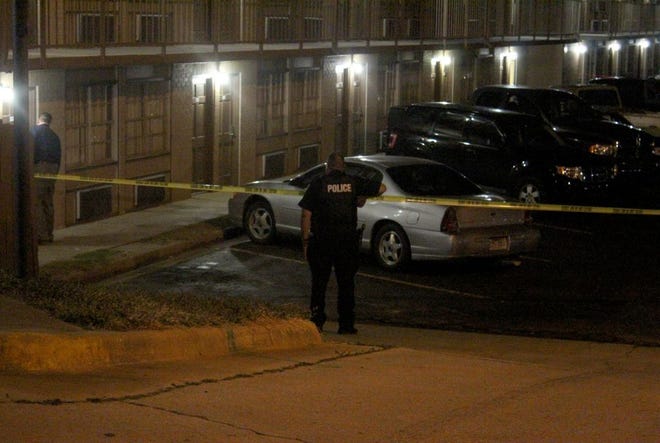 A Fort Smith police officer works the scene of a fatal shooting Thursday night at River Valley Inn & Suites, 5103 Towson Ave. [Max Bryan/Times Record]