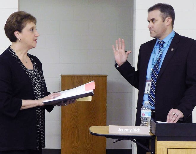 Newly appointed Central Valley Superintendent Jeremy Rich, right, takes the oath of office during Thursday's school board meeting. Administering the oath is District Clerk Marsha Griffith. [DONNA THOMPSON/TIMES TELEGRAM]