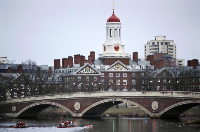 FILE - In this March 7, 2017 file photo, rowers paddle along the Charles River past the Harvard College campus in Cambridge, Mass. [AP Photo/Charles Krupa, File]