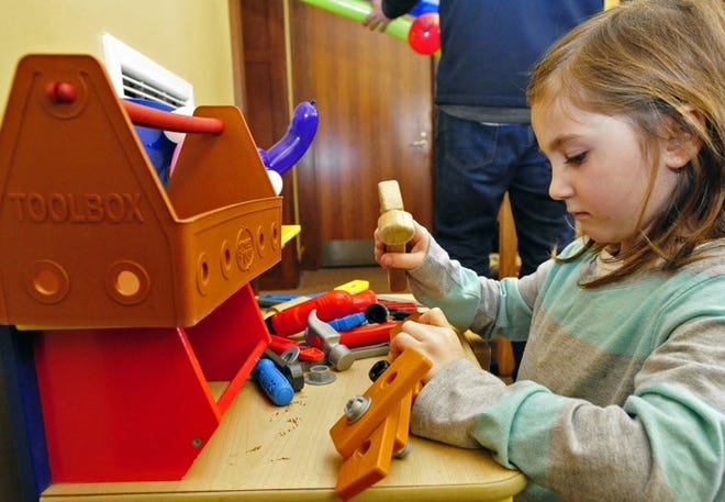 Scarlett Davidson tries out the tool bench recently at the Mattapoisett Free Public Library on Barstow Street. [DAVID W.OLIVEIRA/STANDARD-TIMES FILE/SCMG]