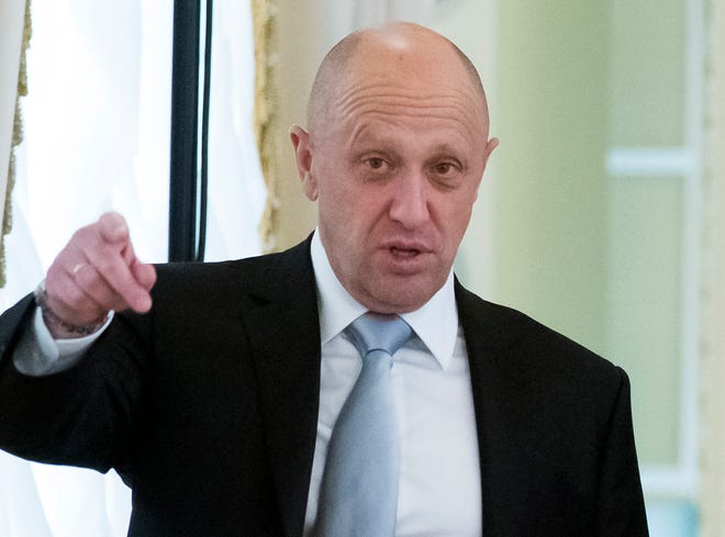 FILE - In this Tuesday, Aug. 9, 2016 file photo, businessman Yevgeny Prigozhin gestures at the Konstantin palace outside St. Petersburg, Russia. One of those indicted in the Russia probe is a businessman with ties to Russian President Vladimir Putin. Prigozhin is an entrepreneur from St. Petersburg who’s been dubbed "Putin's chef" by Russian media. His restaurants and catering businesses have hosted the Kremlin leader's dinners with foreign dignitaries. (AP Photo/Alexander Zemlianichenko, file)