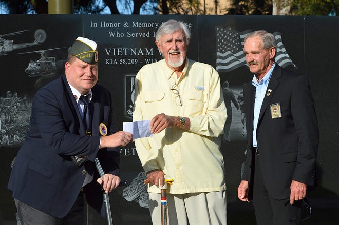Don Van Beck, who orchestrated the effort to have a vintage Huey helicopter installed as a Vietnam veterans memorial at Veterans Memorial Park in downtown Leesburg, presents a check for $1,000 to¬†AmVets 2006 Post Commander Randy Peterson¬†on Wednesday. Van Beck's donation was to help Post 2006 pay for the upkeep of the monument. Pictured are Peterson, Van Beck and AmVets National Commander Marion Polk. [Whitney Lehnecker/Daily Commercial]