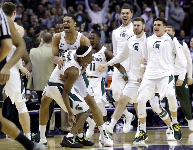 Michigan State guard Cassius Winston, left, celebrates with guard/forward Miles Bridges after scoring a basket during the second half of a game against Northwestern on Saturday in Rosemont, Ill. Michigan State won 65-60. [AP Photo / Nam Y. Huh]
