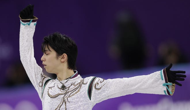 Yuzuru Hanyu performs during the men's free figure skating final in the Gangneung Ice Arena at the 2018 Winter Olympics in Gangneung, South Korea on Saturday. [AP Photo/Bernat Armangue]