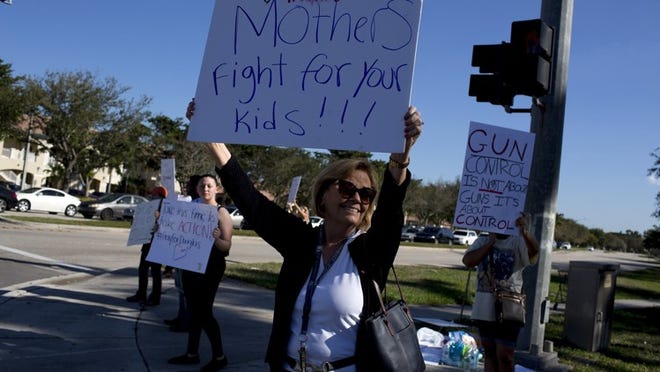 Protesters along a road in Coral Springs, two days after a shooting at the nearby Marjory Stoneman Douglas High School. (Saul Martinez/The New York Times)